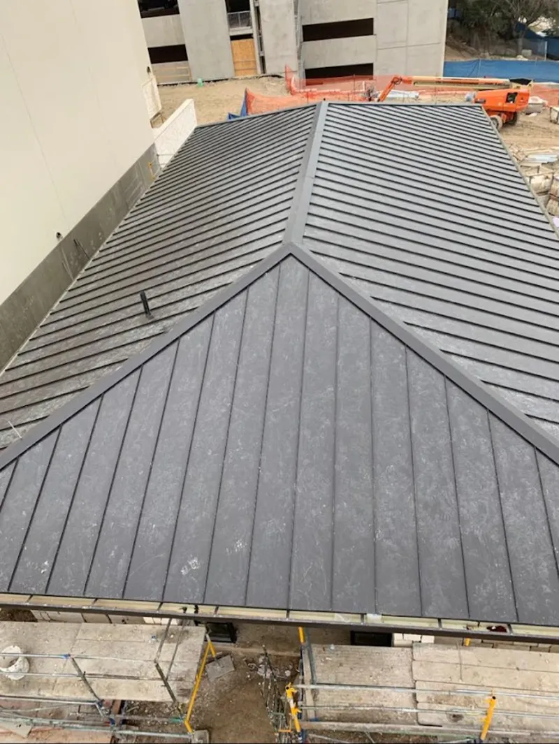 Commercial metal roof construction with crane equipment in Belleview