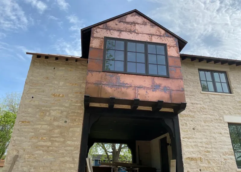 Copper metal panel facade on a stone building for Skylight Installation in Belleview