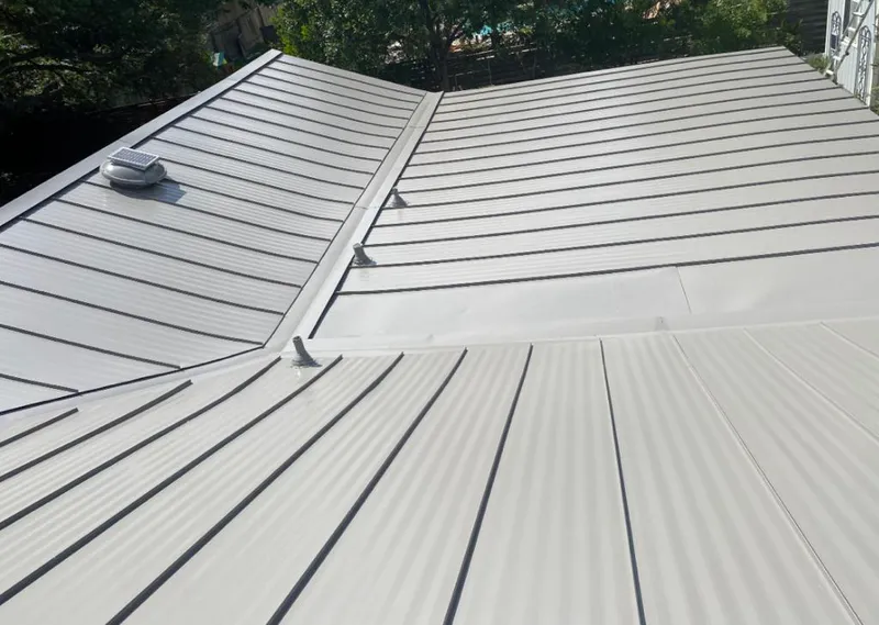 Solar attic fan installed on a metal roof for Roof Ventilation in Belleview
